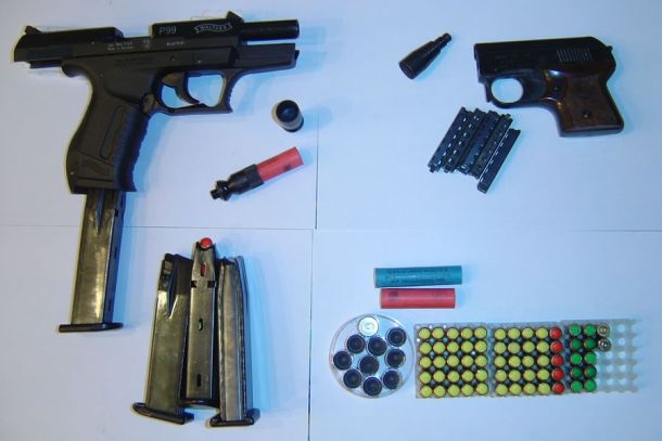 Schreckschusspistolen Walther P99 (l.) und Röhm Mod. 3S (r.), Patronen (blau = CN, gelb = CS, rot = Pfeffer und sonstige Reizstoffe, grün = Platz) und Signalmunition