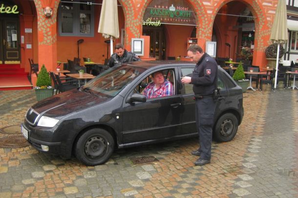 Das Foto zeigt einen auf dem Marktplatz kontrollierten Verkehrsteilnehmer, der diesen Bereich mit einer Ausnahmegenehmigung befahren durfte. Hinter dem Fahrzeug ist PK Carl, vor dem Fahrzeug PK Krafczyk zu sehen.